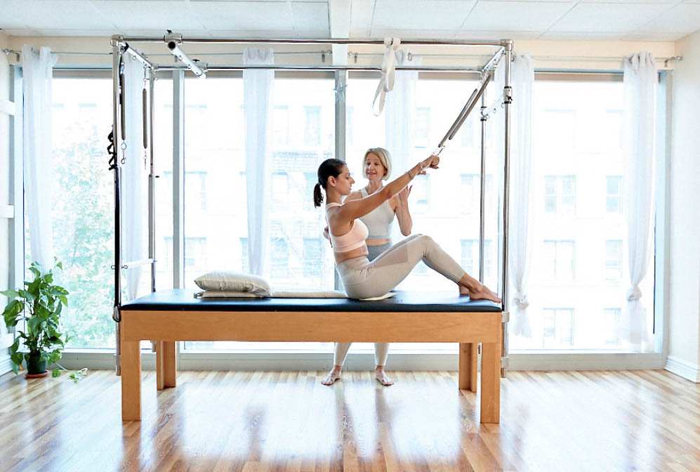 Varvara Kalinin teaching a client during a private Pilates session in Astoria NY